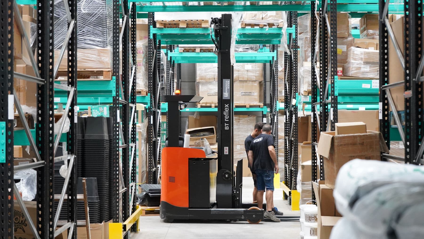Warehouse aisle with a forklift and shelving