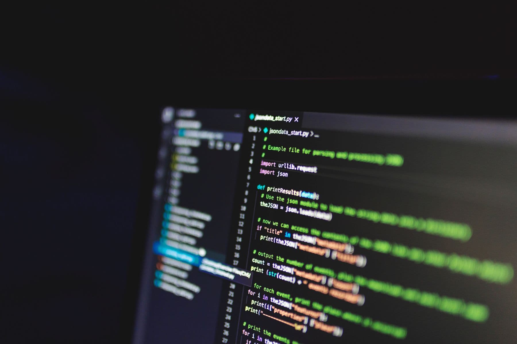 Code editor open on a laptop in a dark room